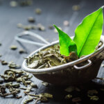Fresh green tea on black wooden table
