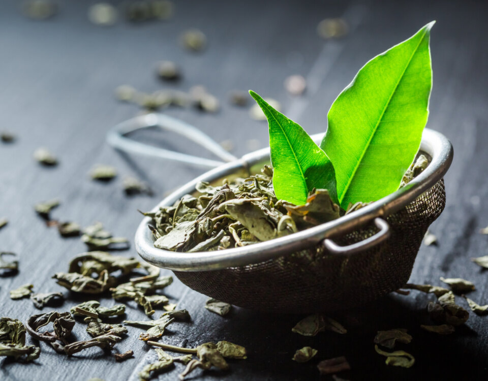 Fresh green tea on black wooden table