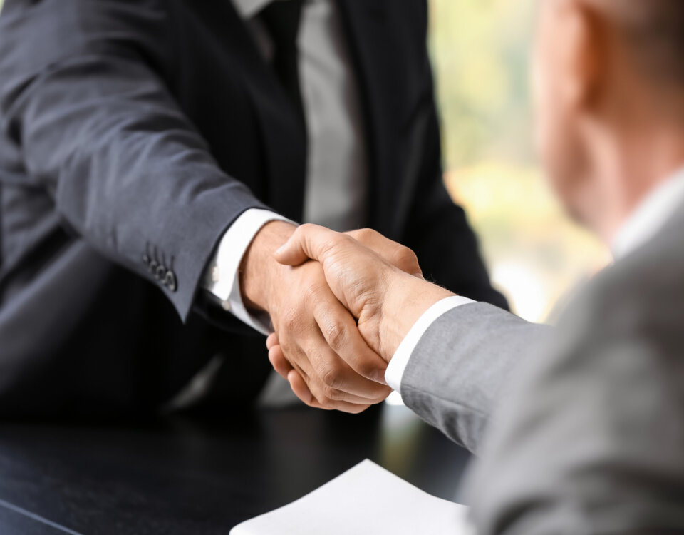 Businessmen shaking hands in office