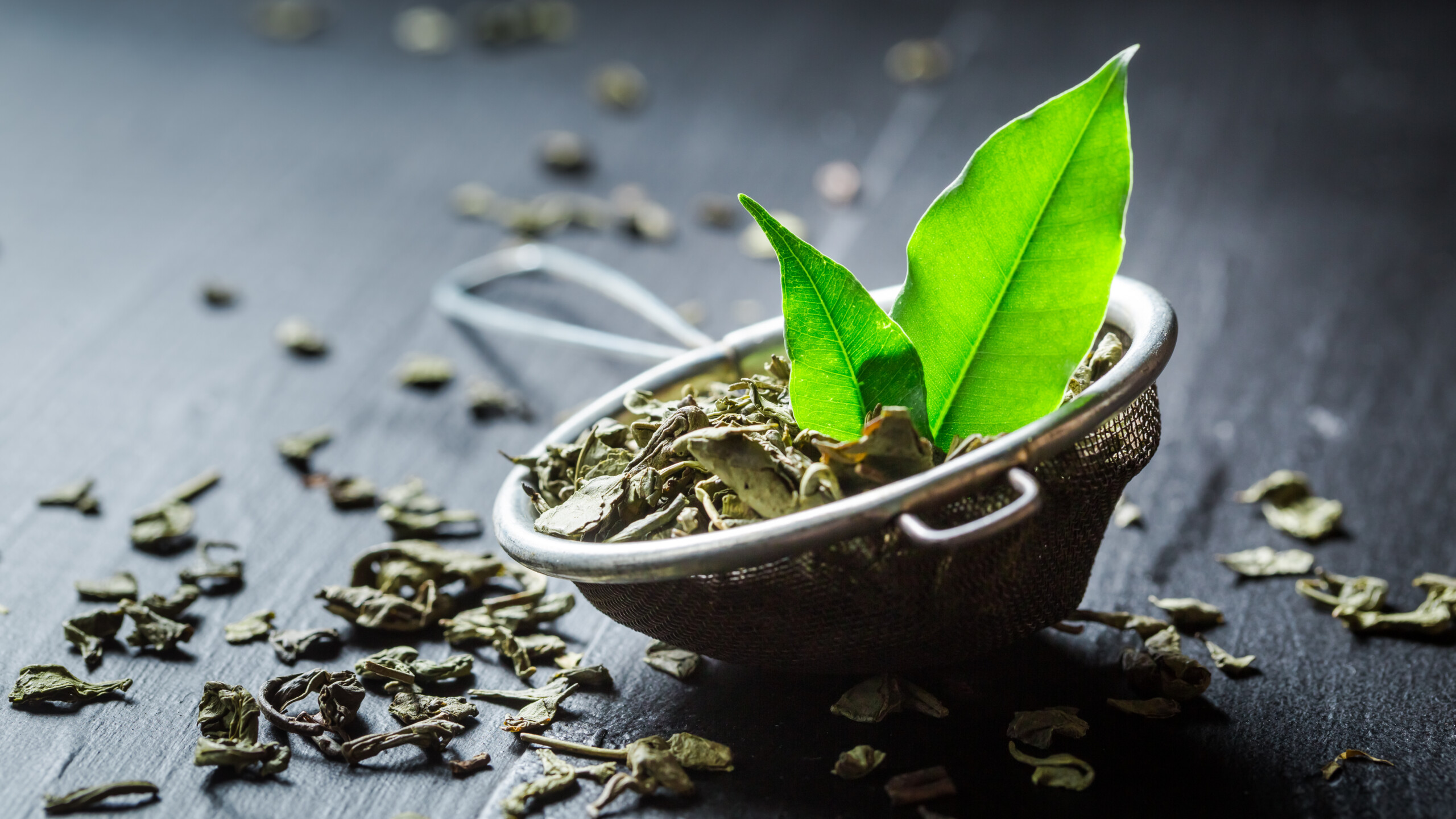 Fresh green tea on black wooden table